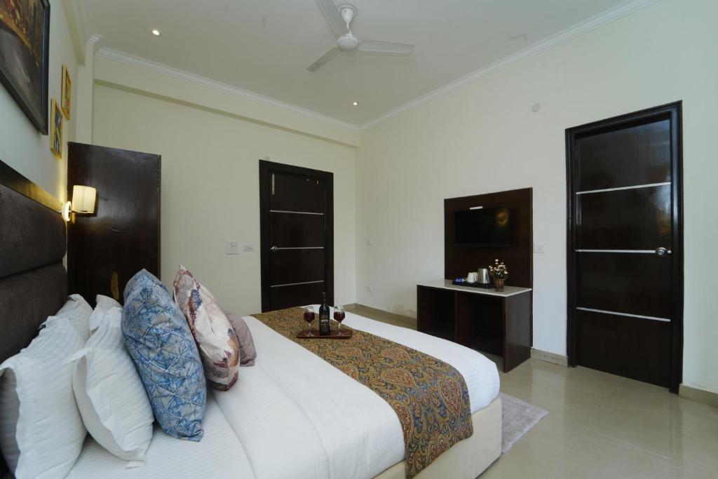 a bedroom with a large bed and two windows at Hotel Rawat in Ludhiana