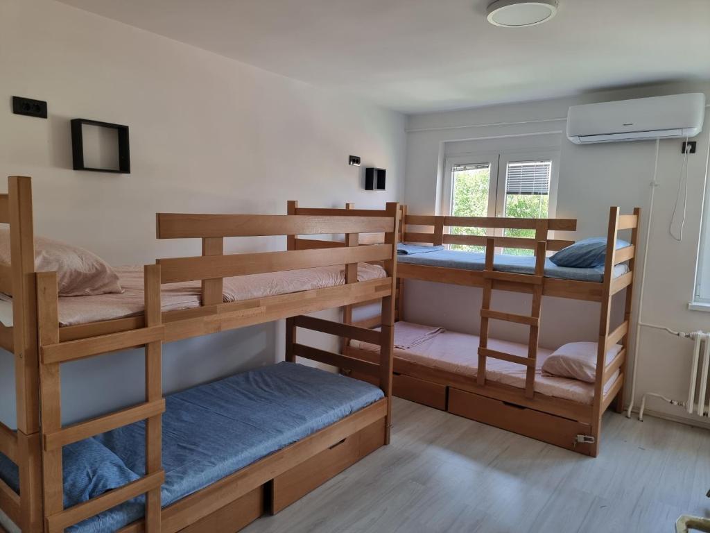 a room with three bunk beds and a window at Bgd Downtown Hostel in Belgrade