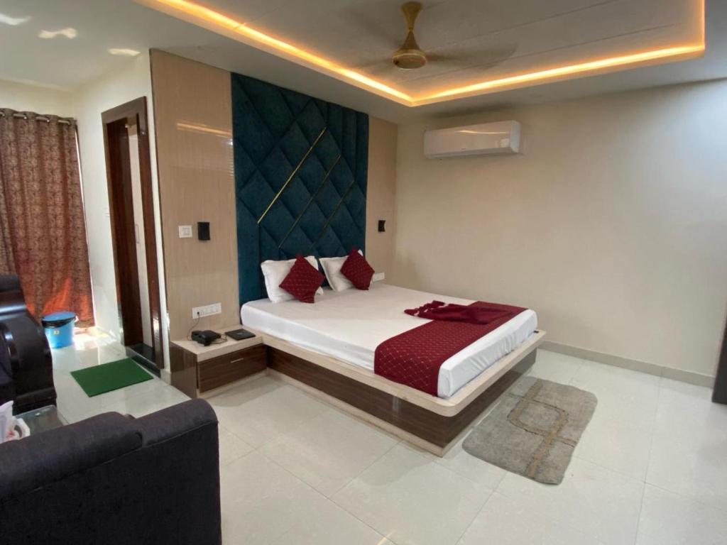 a bedroom with a large bed and a couch at Dayal International - New Digha in Digha