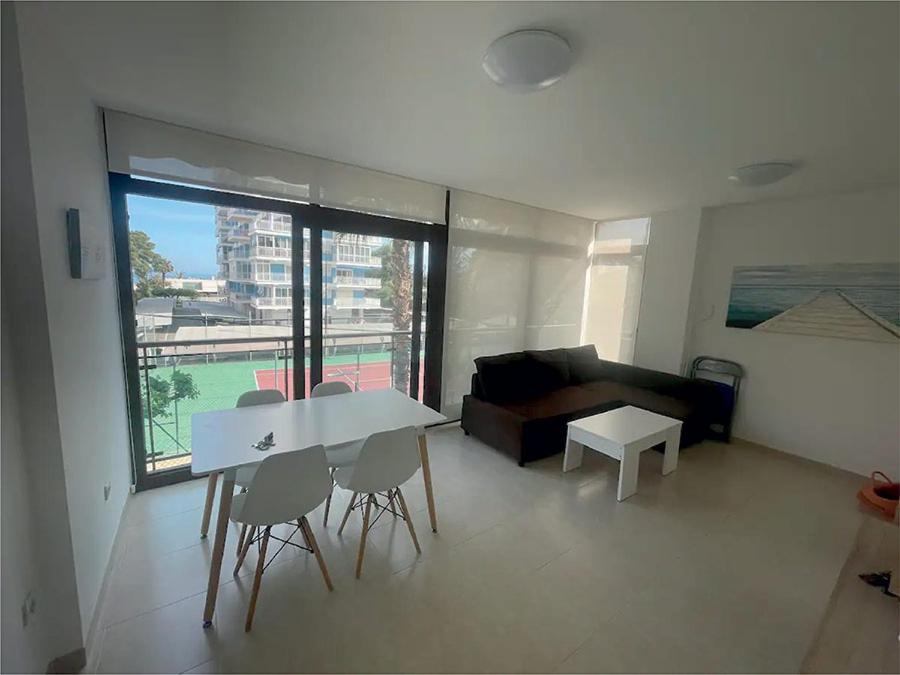 a living room with a table and chairs and a couch at Mirador dels Terrers in Benicàssim