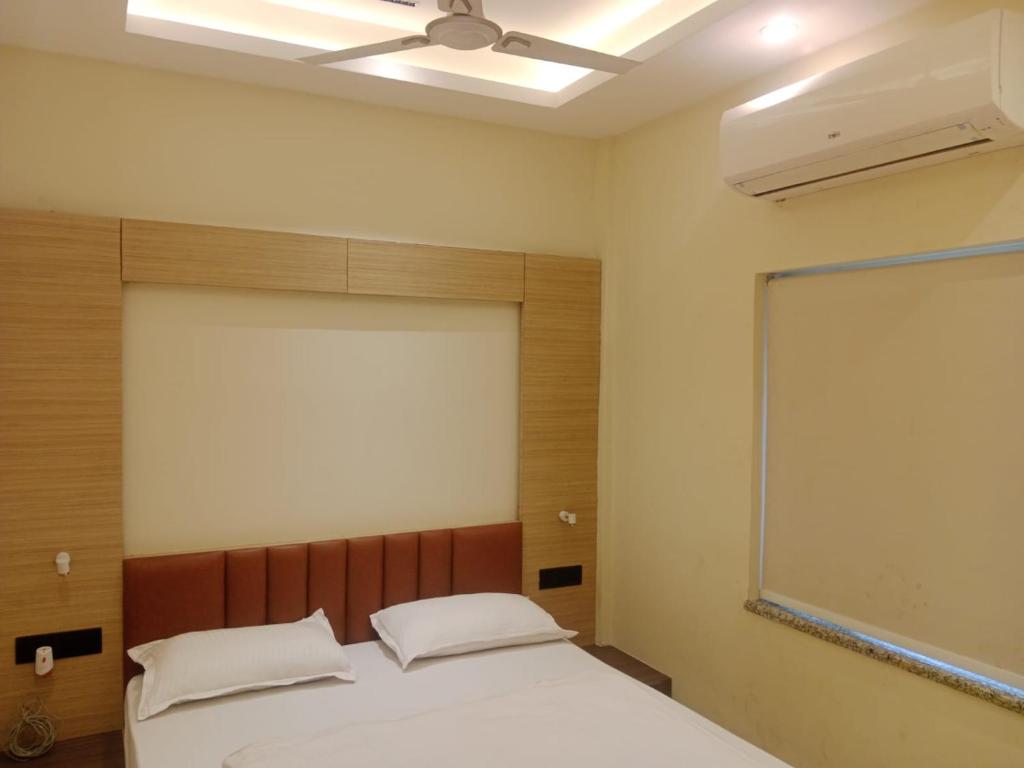 a bedroom with a bed and a projector screen at HOTEL SKYKING in Gauripur