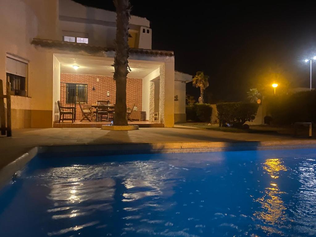 a swimming pool in front of a house at night at Chalet La Sopera La Manga in La Manga del Mar Menor