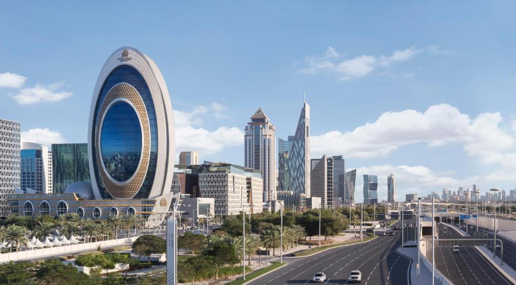 a view of a city with a highway and buildings at Velero Hotel Doha Lusail in Doha