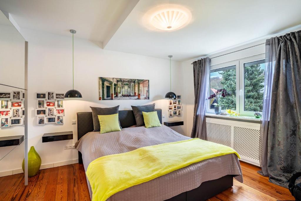 a bedroom with a bed with a yellow blanket at Wohnung Lichtentaler Allee in Baden-Baden