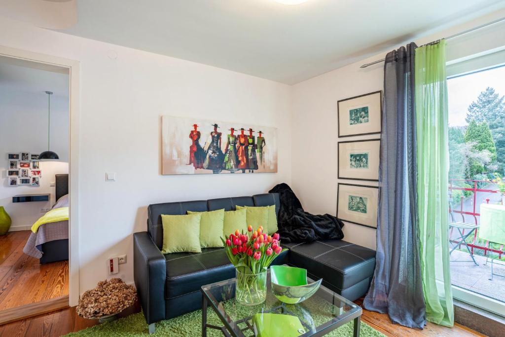 a living room with a couch and a table at Wohnung Lichtentaler Allee in Baden-Baden