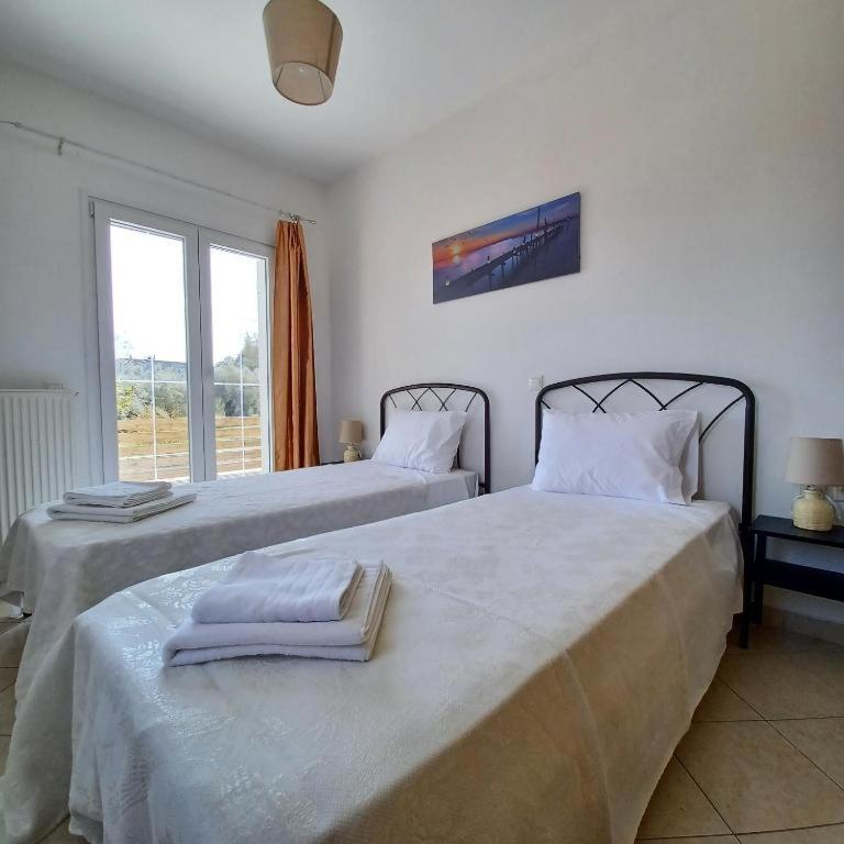 Postel nebo postele na pokoji v ubytování Eleonas Apartment 2, Lygia