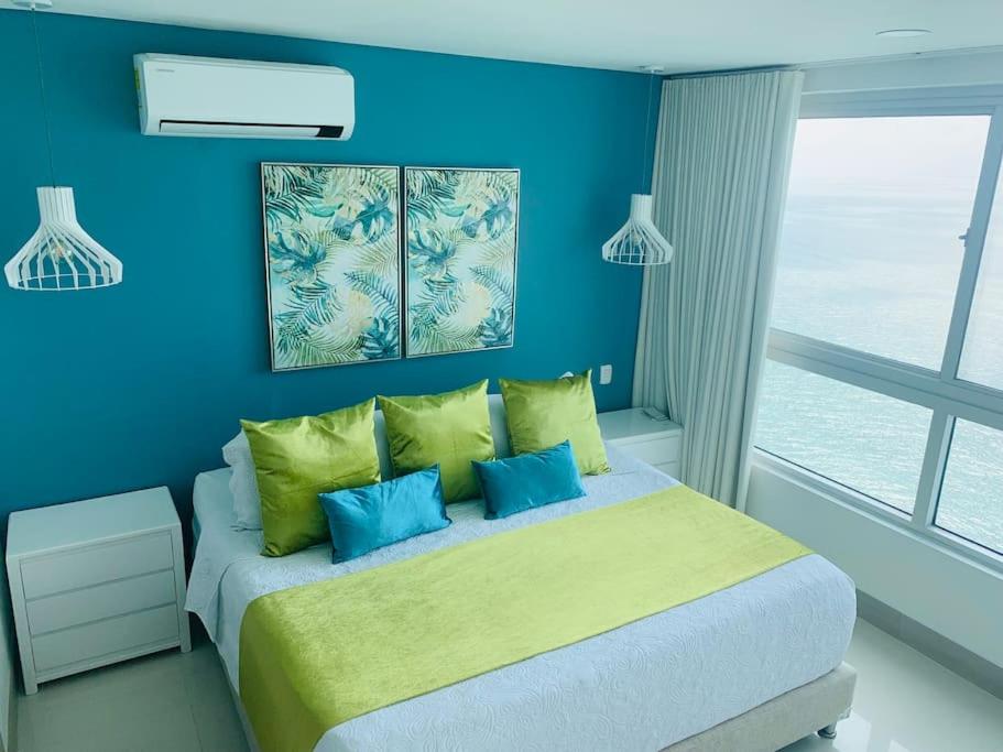 a blue bedroom with a bed with blue walls at Apartament Bocagrande Palmetto Beach Front 3204 in Cartagena de Indias