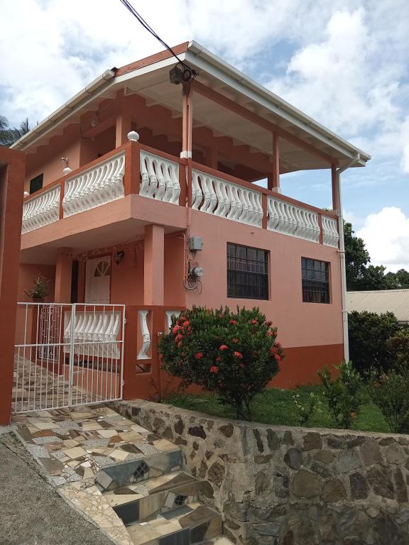 a house with a balcony in front of it at Angie's Cove, modern get-away overlooking Castries in Castries