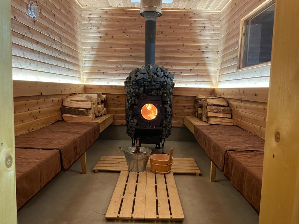 a sauna with a wood burning stove in it at Private sauna stay Shinori - Vacation STAY 34530v in Hakodate