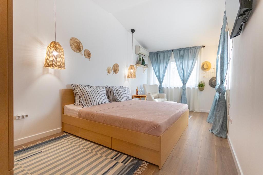 a bedroom with a bed and a room with a window at Apartment Tulip in Varna City