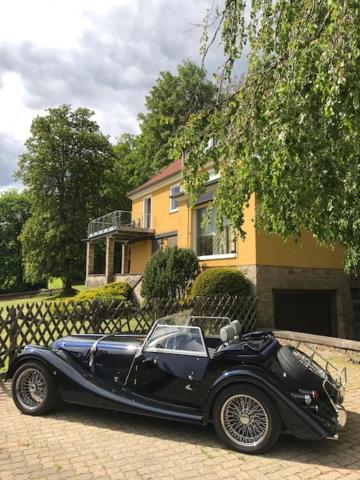 a black car parked in front of a house at Villa Mara in Bad Lauterberg