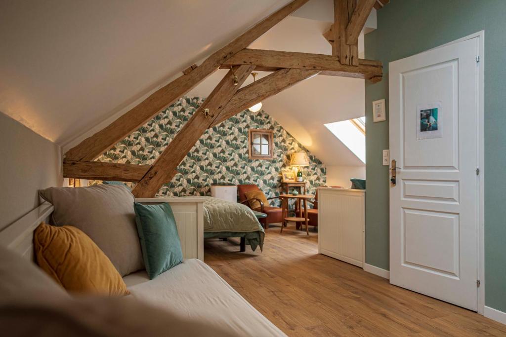 a bedroom with a bed and a room with a attic at LES OLIVANIES 