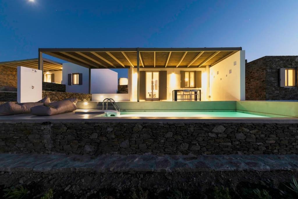 a house with a swimming pool at night at Luxury villa with private pool in Dhriopís