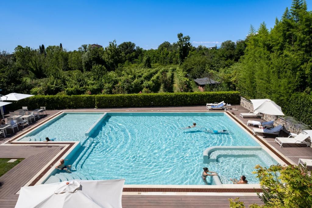 a pool at a resort with people swimming in it at The Ziba Hotel & Spa in Peschiera del Garda