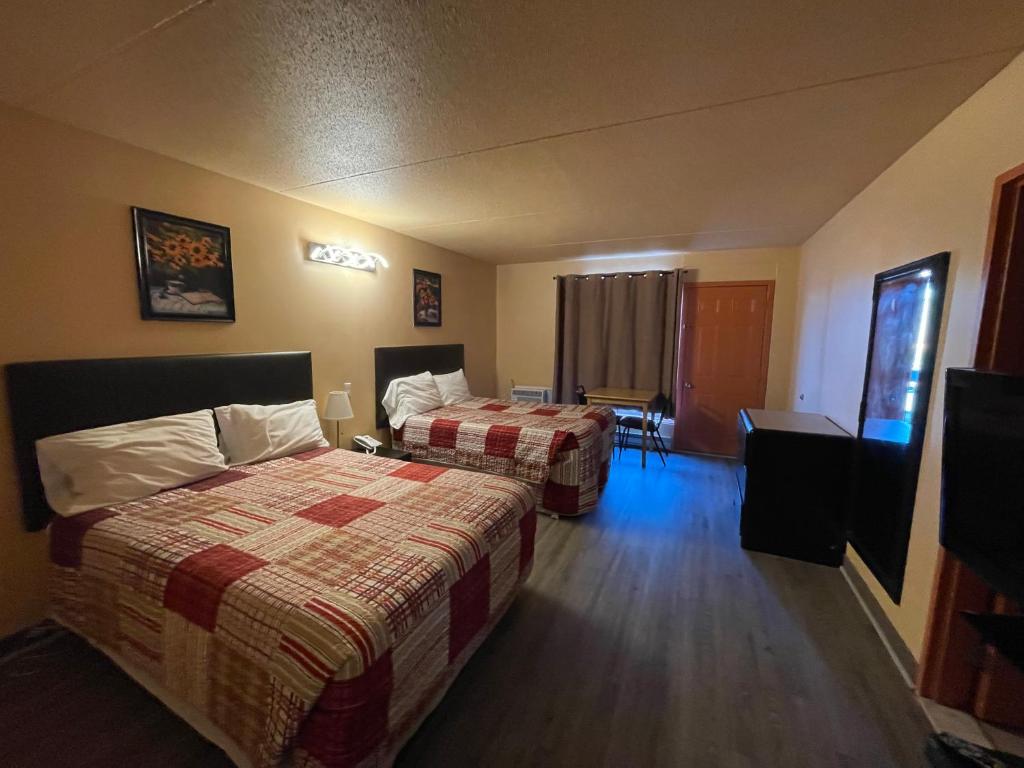 Postel nebo postele na pokoji v ubytování Motel St-Eustache