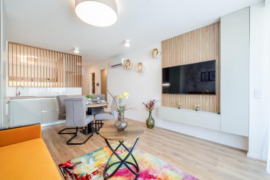 a living room with a kitchen and a dining room at MyFlat Wave Olive Apartment in Siófok