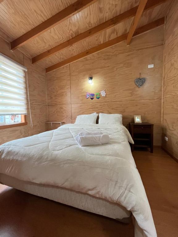 En eller flere senge i et værelse på Departamentos NuBe1 Castro Chiloé