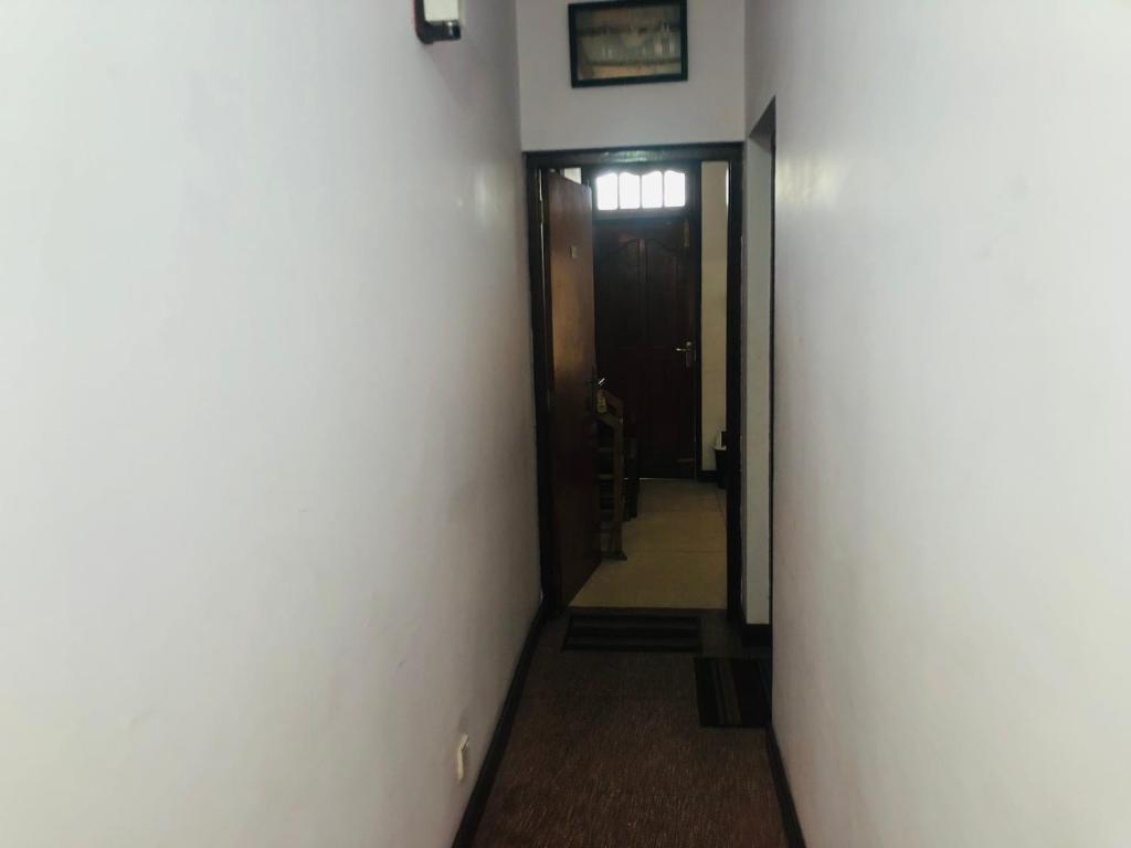 a hallway with a hallway leading to a door at Summer hill rest in Nuwara Eliya