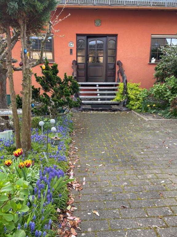 a house with a garden of flowers in front of it at Farben Haus in Kail