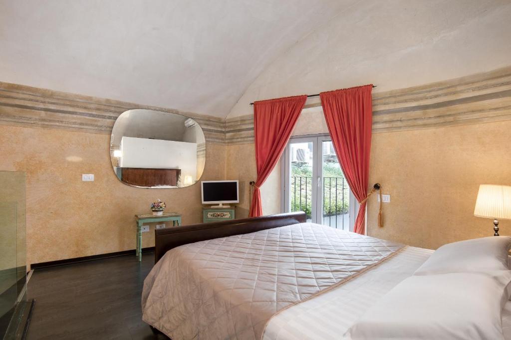 a bedroom with a large bed and a mirror at Asso Residence Narni in Narni