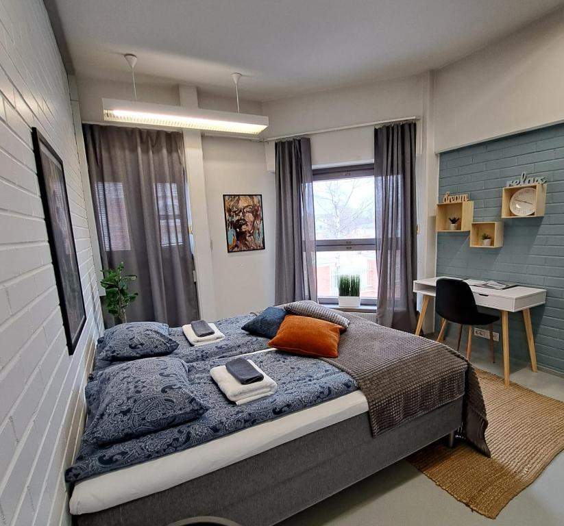 a bedroom with a bed and a desk in it at WatchHouse in Hamina