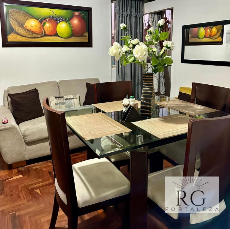 a dining room with a glass table and chairs at Linda casa amoblada barrio santa isabel in Bogotá