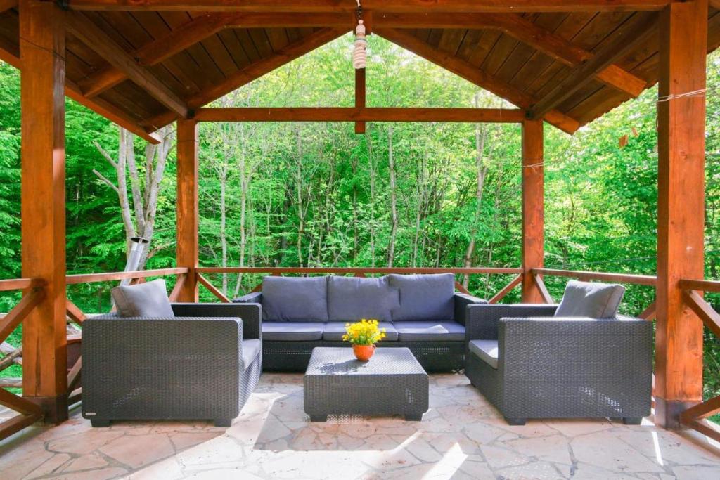 un patio cubierto con sofás y una mesa en Lost In Nature! Dream House in Dilijan National Park!, en Dilijan