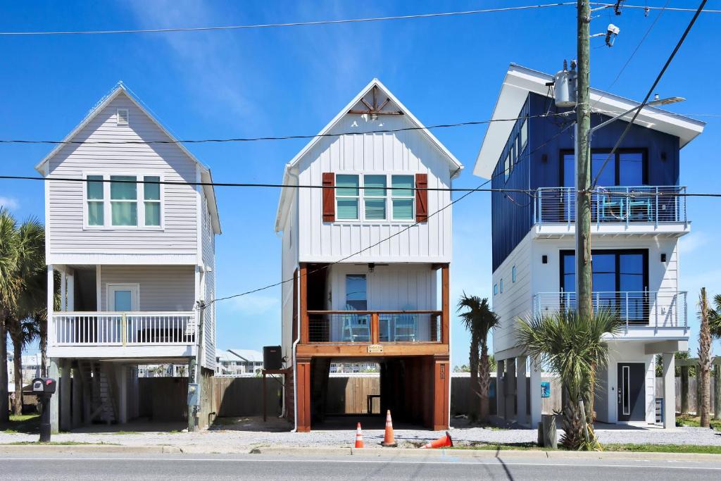 two houses on the side of a street at Bucket List by Pristine Properties Vacation Rentals in Mexico Beach