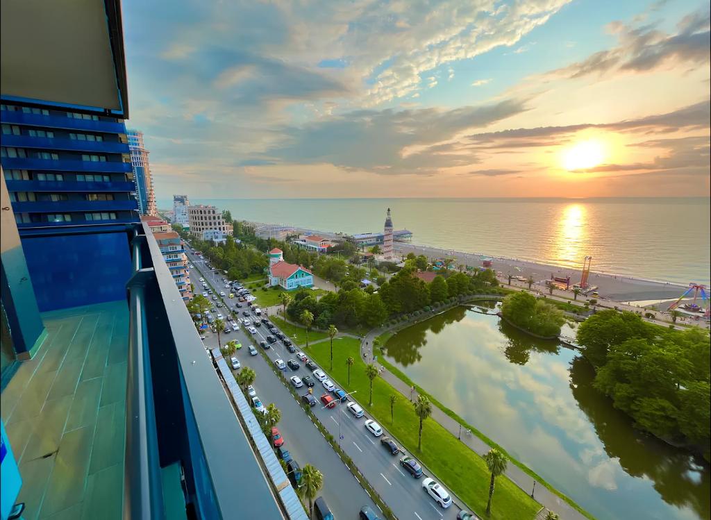 a view of a city from a balcony with traffic at PANORAMA Orbi Beach Resort Center Suite in Batumi