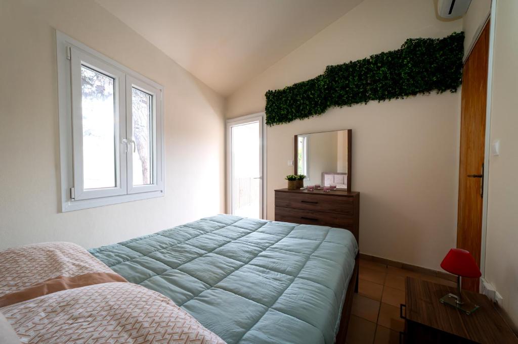 a bedroom with a bed and a dresser and a mirror at Hillside Home in Platres in Platres