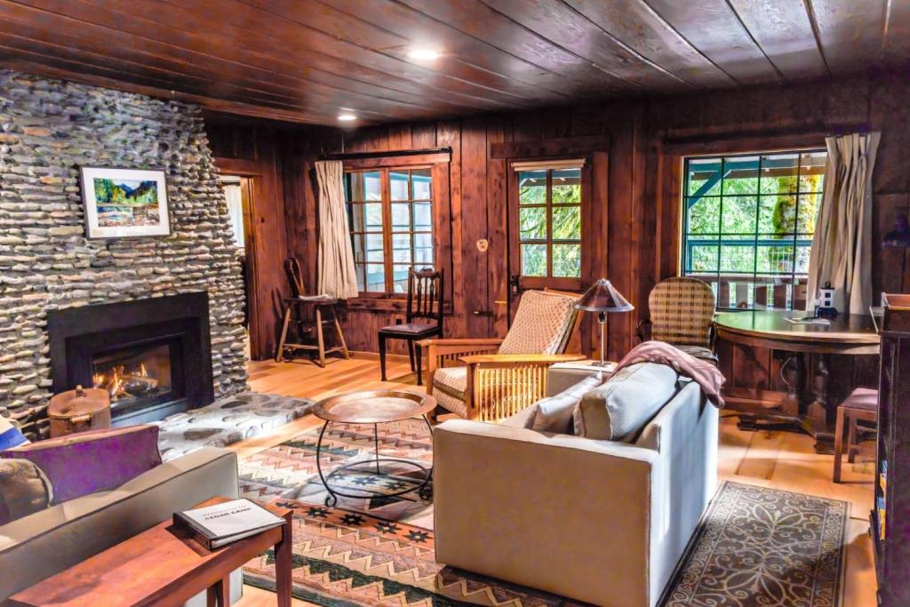 a living room with a couch and a fireplace at Cedar Camp in Welches