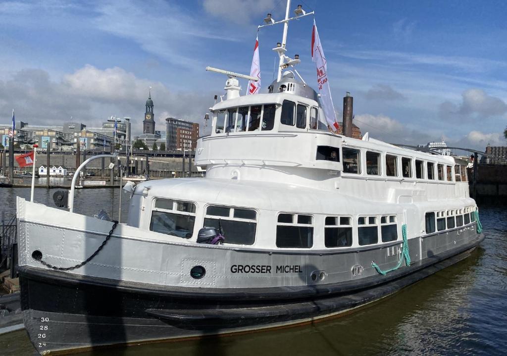 a cruise boat is docked in the water at Eventschiff Grosser Michel in Hamburg