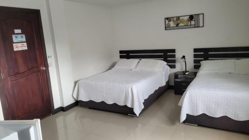 A bed or beds in a room at Hostal Marlyn