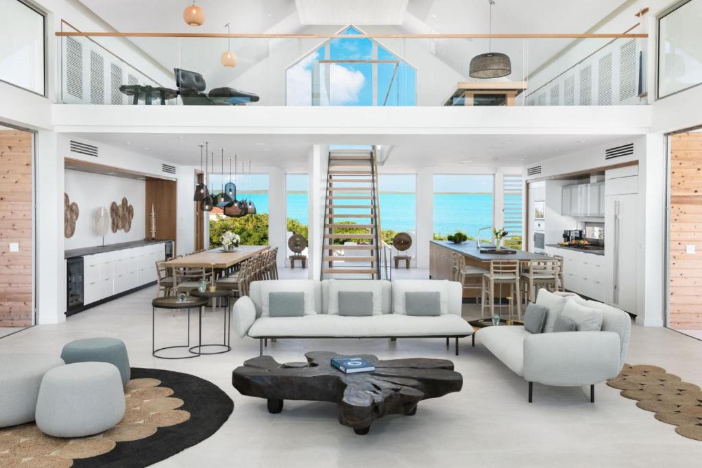 a living room with white furniture and the ocean at La Mer South, Luxury Oceanfront on Sapodilla Bay in Providenciales