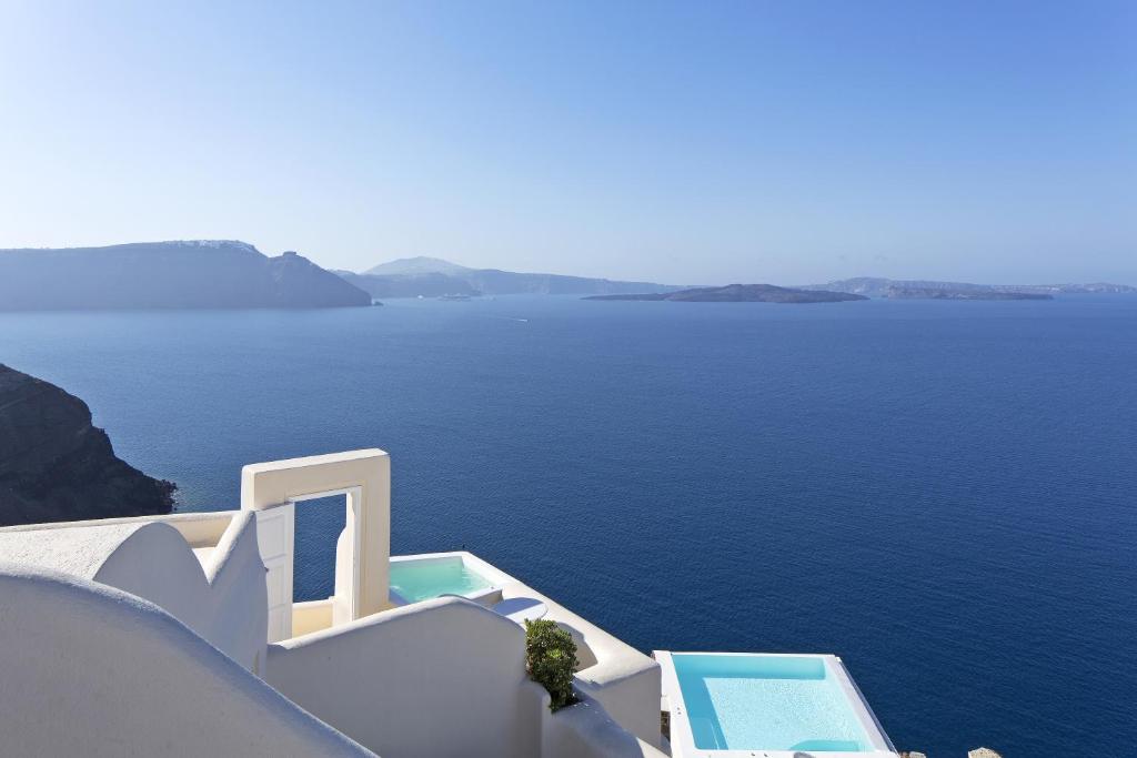 a view from a balcony overlooking the ocean at Canaves Oia Suites & Spa in Oia