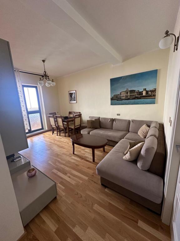 a living room with a couch and a table at You will love it in Durrës