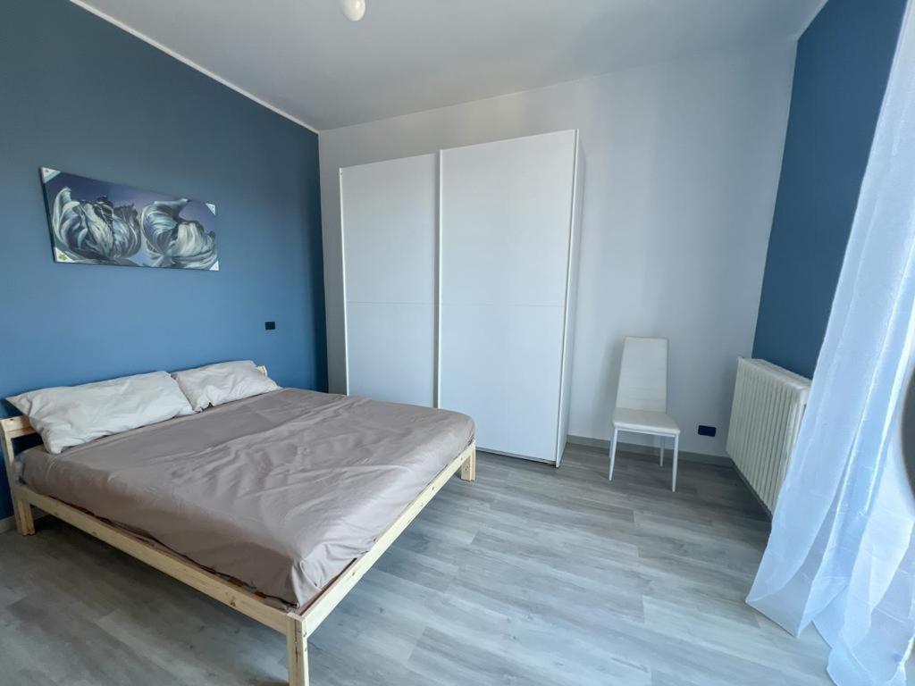 a bedroom with a bed and a blue wall at LIBARNA in Serravalle Scrivia
