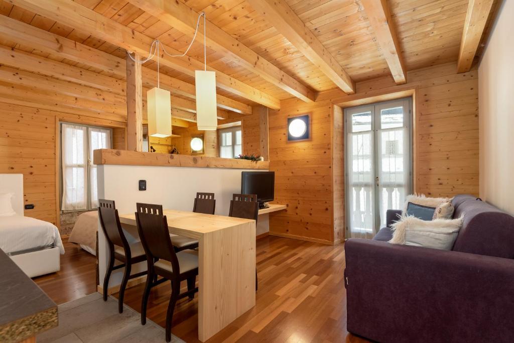 a dining room and living room in a log cabin at Locanda Cantù in Carona