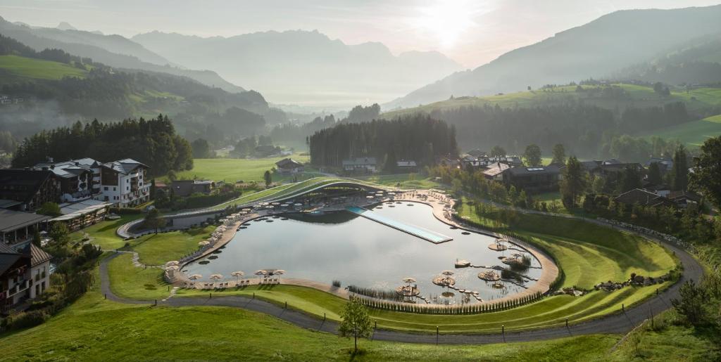 an aerial view of a resort with a lake at Hotel Krallerhof in Leogang