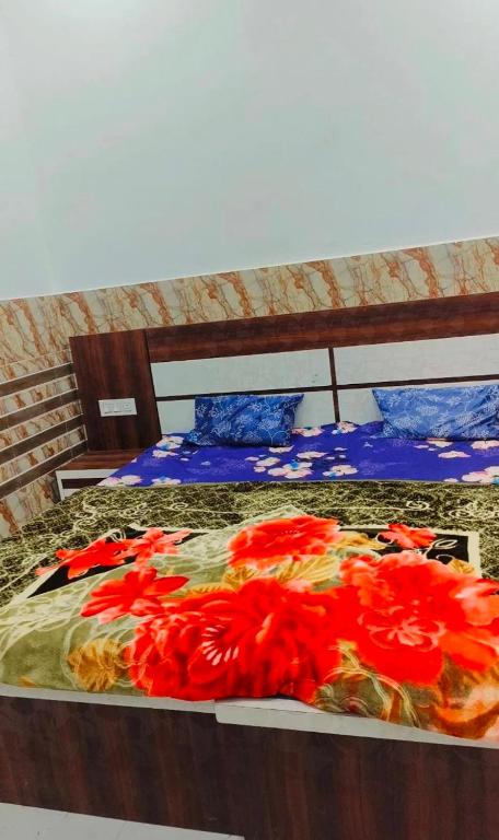 a pile of red flowers on a bed at Shri Ganesh Seva Sadan in Govardhan
