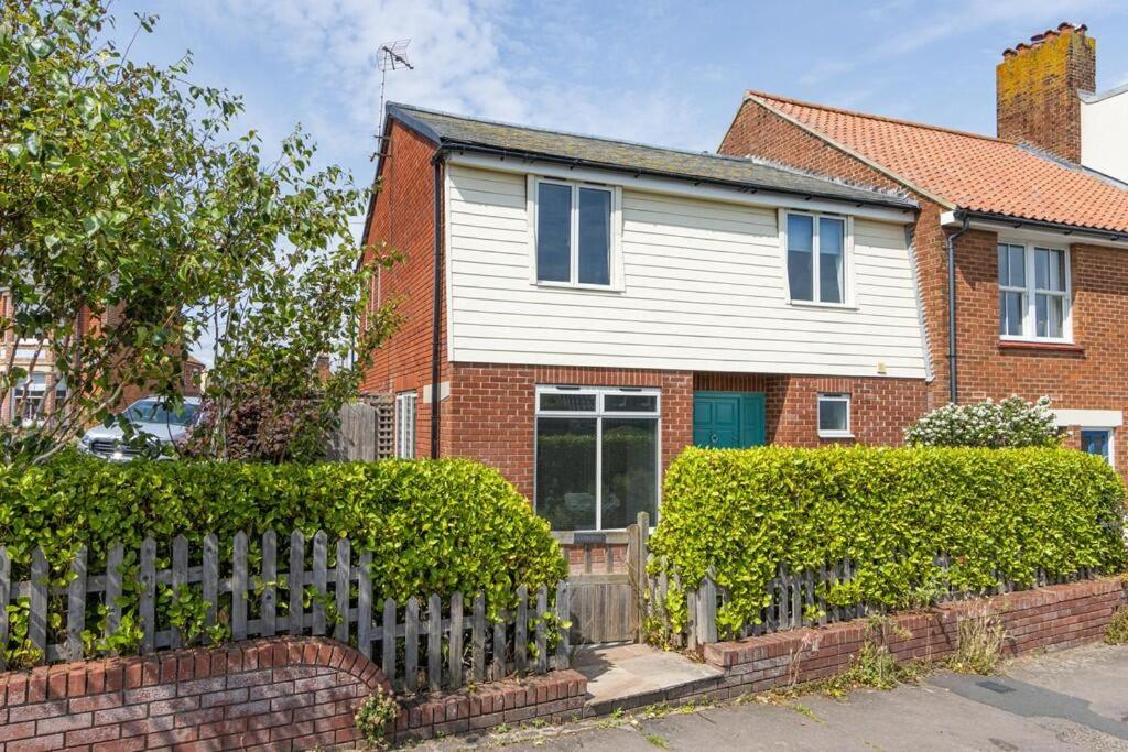 a house with a fence in front of it at Sea View Cottage Southwold in Southwold