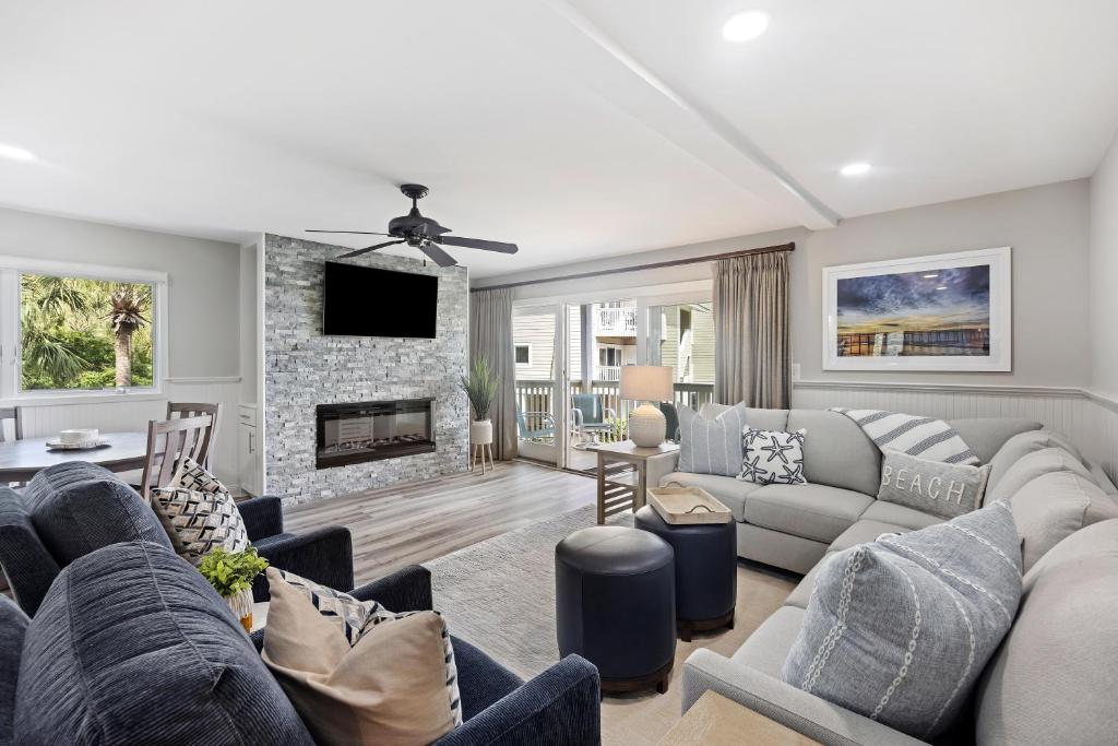 a living room with a couch and a fireplace at 8A Seagrove Villa in Isle of Palms
