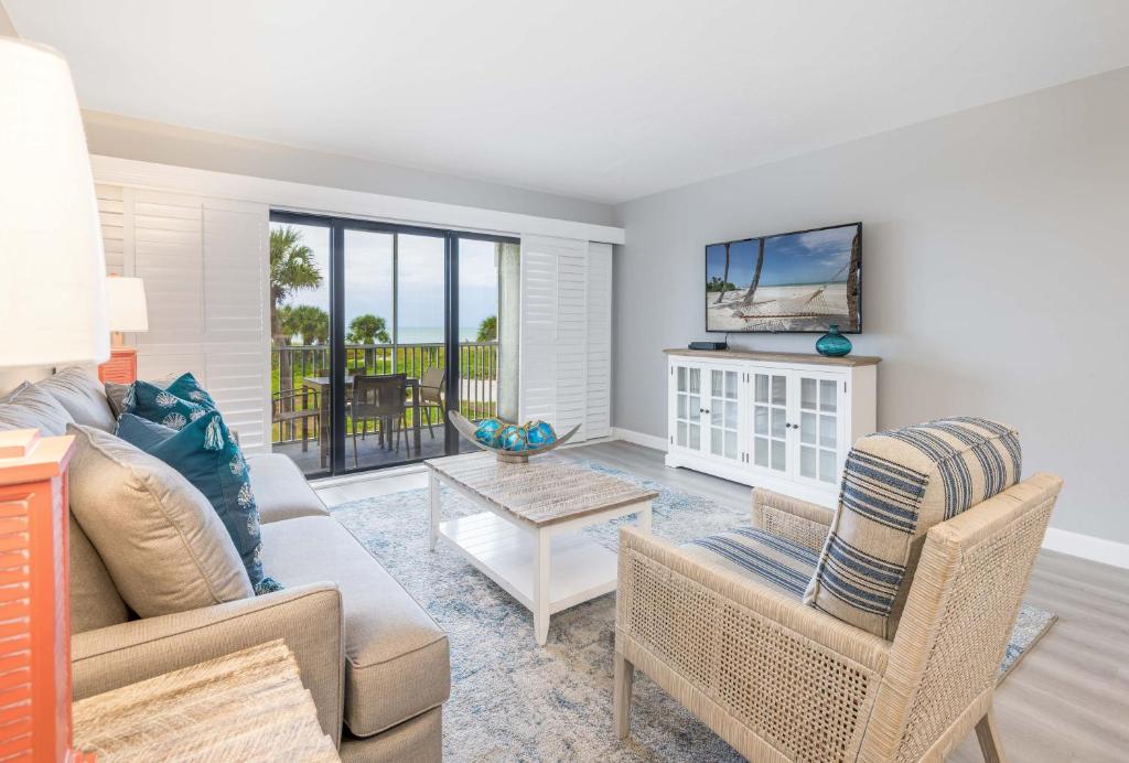 a living room with a couch and a tv at South Seas Resort - Official Site in Captiva