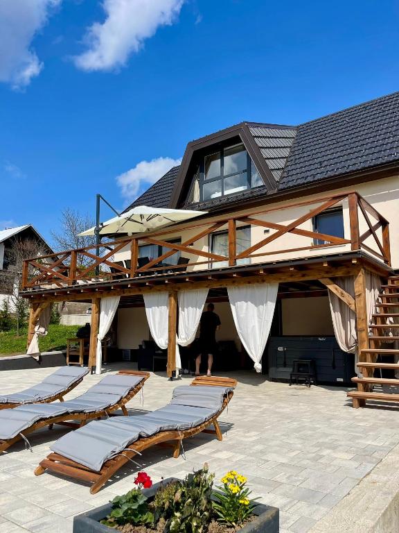 a house with a bunch of beds on a patio at Holiday Home Zagorka in Ogulin