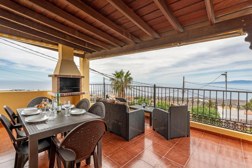a patio with a table and chairs and a fireplace at Gran Casa Rural Tijoco Bajo Adeje in Adeje