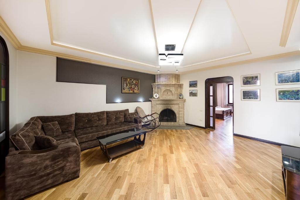 a living room with a couch and a fireplace at 2-BDR/Perfect Location/Cozy in Yerevan