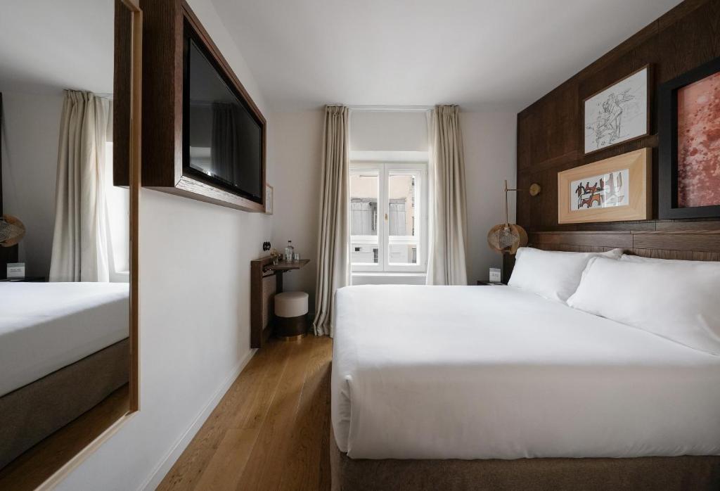 Postel nebo postele na pokoji v ubytování Hotel Pulitzer Paris
