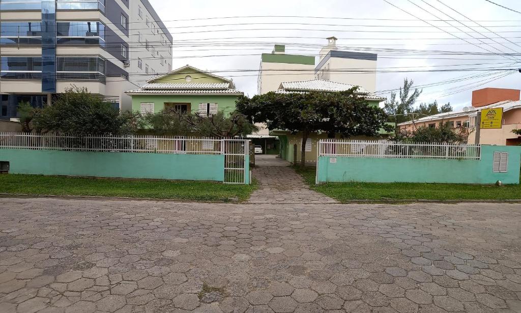 a house with a fence in front of it at Apartlaguna in Laguna