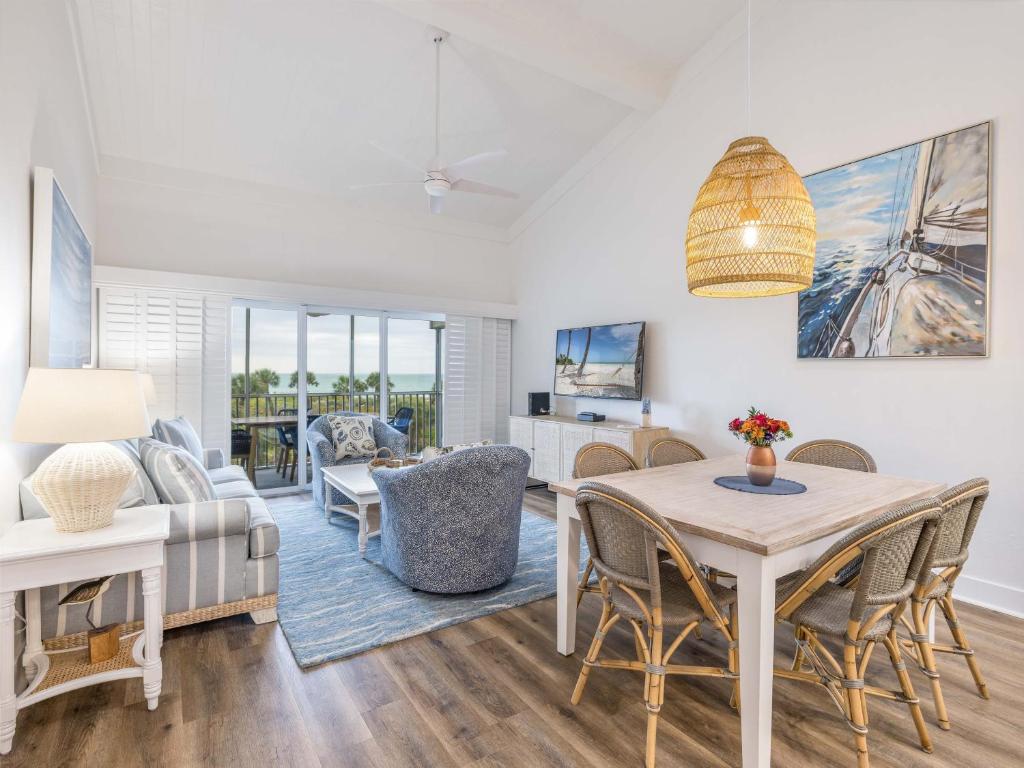 a living room with a table and chairs and a couch at South Seas Resort - Official Site in Captiva