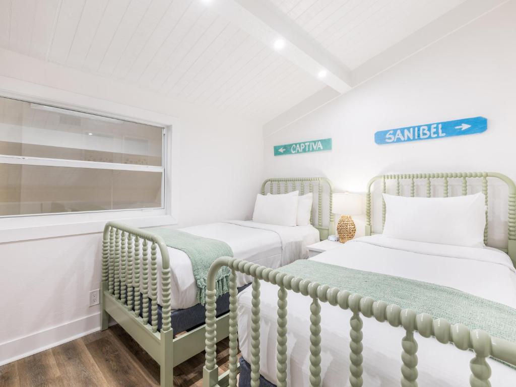 a bedroom with two beds and a window at South Seas Resort - Official Site in Captiva